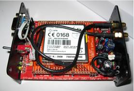 A circuit board with wires and a white label

Description automatically generated